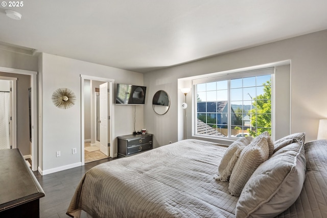 bedroom featuring dark wood-style floors and baseboards