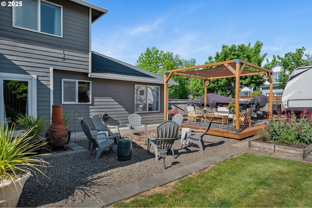 view of patio / terrace with a deck and an outdoor fire pit