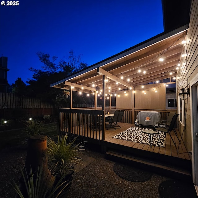 deck at twilight with fence