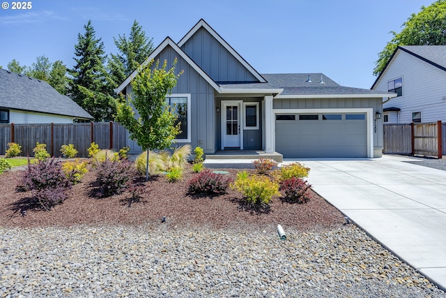 91209 N Coleman St, Eugene, OR 97408 - view of front facade featuring board and batten siding, an attached garage, driveway, and a shingled roof