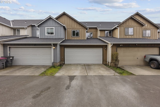 townhome / multi-family property featuring a garage, concrete driveway, a shingled roof, and board and batten siding