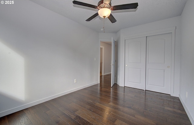 unfurnished bedroom featuring a closet, ceiling fan, baseboards, and dark wood-style flooring