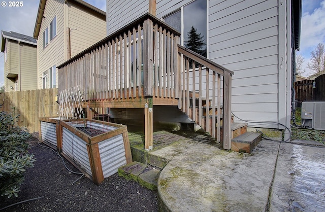 wooden deck with stairway, central AC, and fence