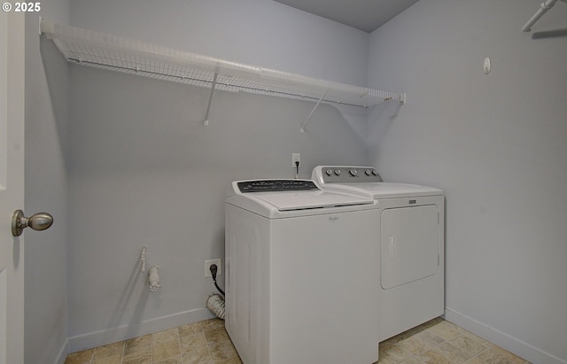 laundry area featuring washer and dryer, baseboards, and laundry area