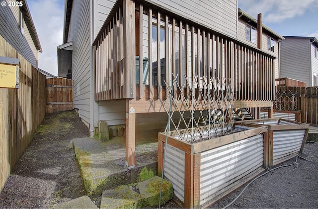 wooden terrace with a garden and fence