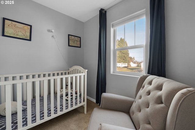 carpeted bedroom with a nursery area