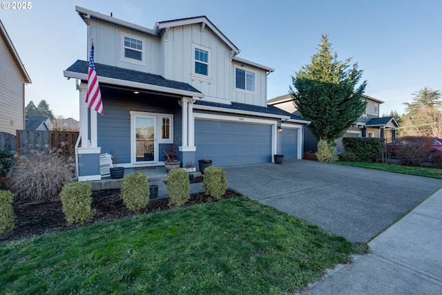 view of front facade with a garage, a front lawn, and covered porch