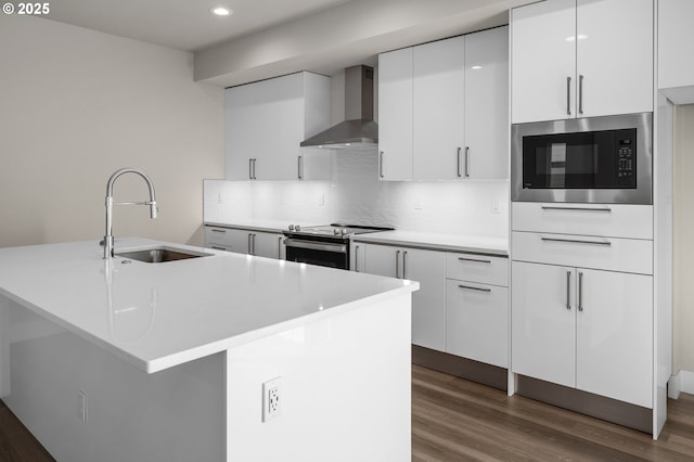 15179 SW Huntwood St, Tigard, OR 97224 - kitchen featuring wall chimney exhaust hood, appliances with stainless steel finishes, decorative backsplash, white cabinets, and recessed lighting