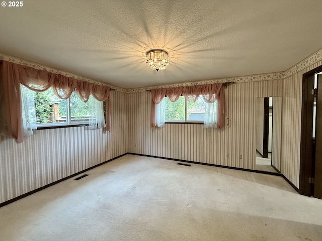 5235 SE 32nd Ave, Portland, OR 97202 - unfurnished room featuring wallpapered walls, a textured ceiling, and carpet floors