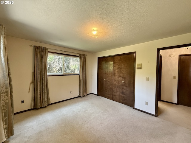 5235 SE 32nd Ave, Portland, OR 97202 - unfurnished bedroom featuring light carpet, a textured ceiling, and a closet