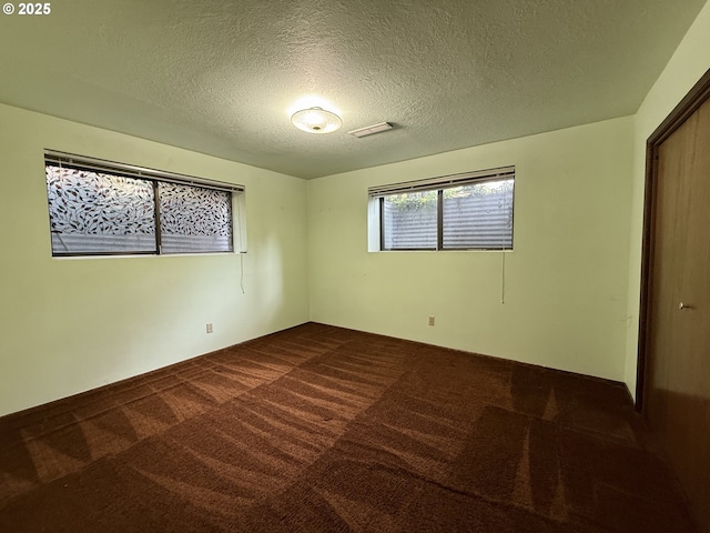 5235 SE 32nd Ave, Portland, OR 97202 - spare room with dark colored carpet and a textured ceiling