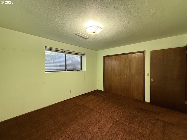 5235 SE 32nd Ave, Portland, OR 97202 - unfurnished bedroom featuring a textured ceiling and dark carpet