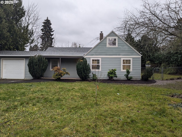 view of front of property featuring a garage and a front yard