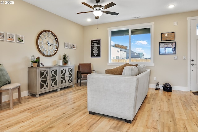 living area with recessed lighting, wood finished floors, visible vents, a ceiling fan, and baseboards