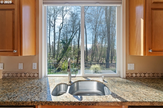 5666 Grand Oaks Dr, Lake Oswego, OR 97035 - kitchen featuring a sink, stone counters, and brown cabinets