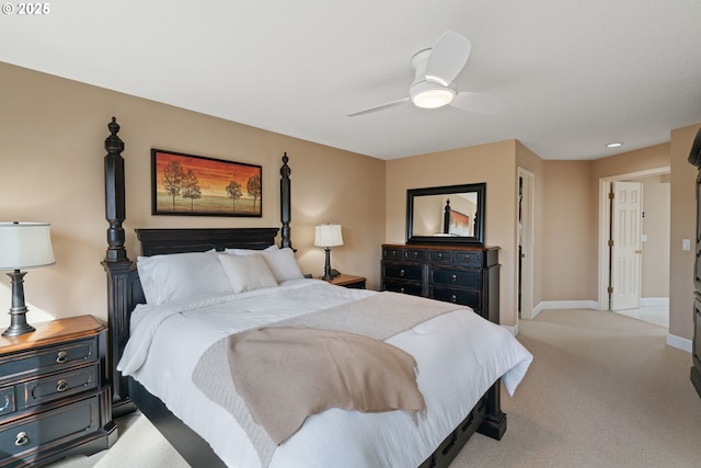 bedroom with light carpet, ceiling fan, and baseboards