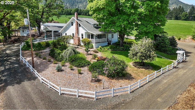 view of home's exterior featuring fence and a chimney