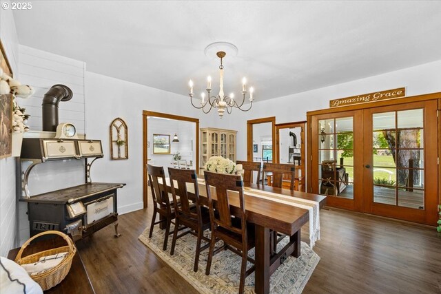 dining room with french doors, a chandelier, and dark wood-style flooring