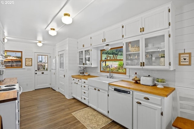 kitchen featuring white appliances, butcher block countertops, white cabinets, wood finished floors, and tasteful backsplash