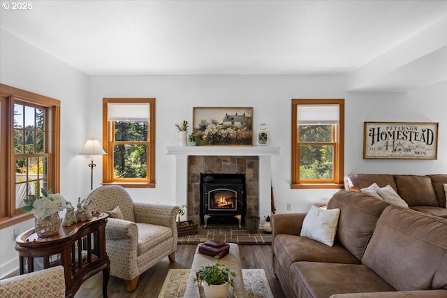 living room featuring healthy amount of natural light, wood finished floors, and a fireplace