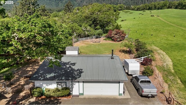 view from above of property with a heavily wooded area