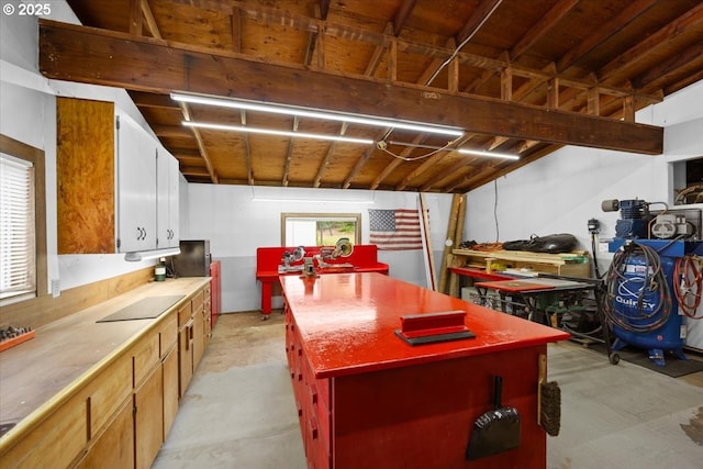 kitchen featuring concrete floors, a kitchen island, and butcher block counters
