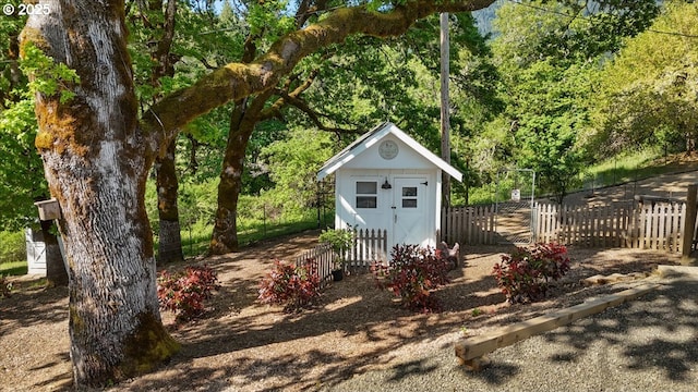 view of shed with fence and a view of trees