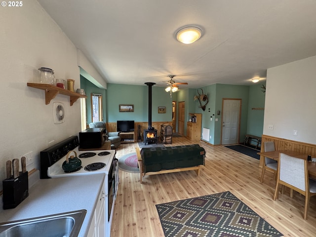 118 Noble Fir, Goldendale, WA 98620 - living room featuring a wood stove, light wood finished floors, and a ceiling fan