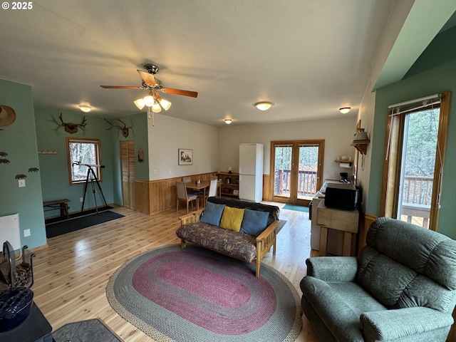 118 Noble Fir, Goldendale, WA 98620 - living area featuring a wainscoted wall, light wood-style flooring, ceiling fan, and wood walls