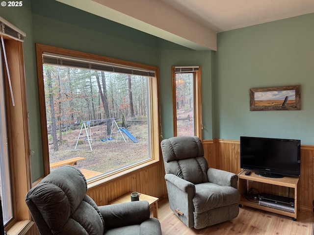 118 Noble Fir, Goldendale, WA 98620 - living area with a wainscoted wall, wood finished floors, plenty of natural light, and wooden walls