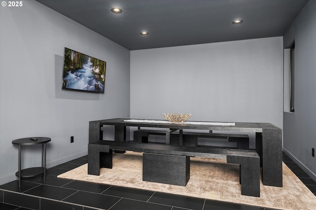 dining space featuring breakfast area and dark tile patterned flooring