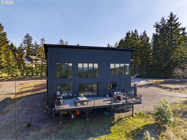 rear view of house with a wooden deck