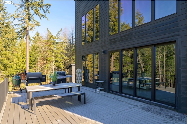 wooden terrace with a grill