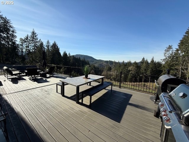 wooden deck featuring an outdoor hangout area and a mountain view