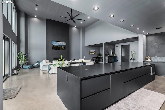 kitchen featuring a spacious island and a towering ceiling