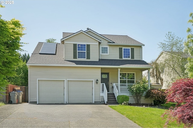 view of front of property featuring roof mounted solar panels, covered porch, a shingled roof, and aphalt driveway
