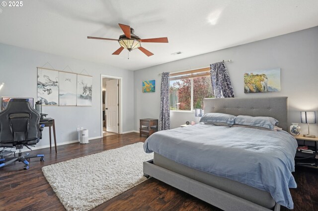 bedroom with ceiling fan, baseboards, visible vents, and wood finished floors