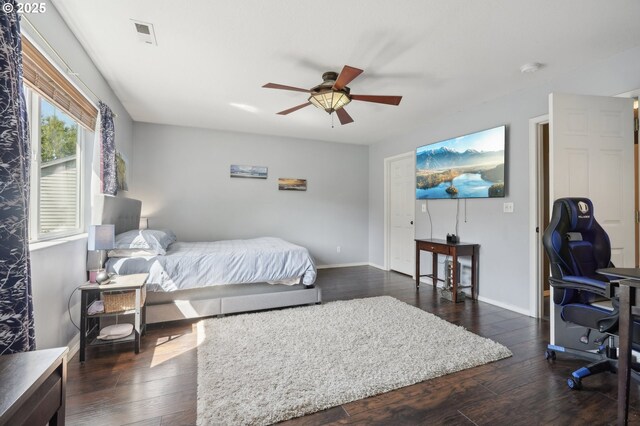 bedroom with baseboards, ceiling fan, hardwood / wood-style floors, and visible vents