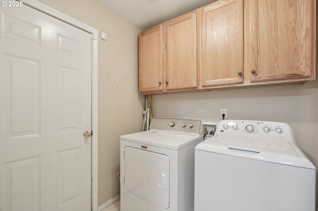 laundry room with cabinet space and washer and clothes dryer