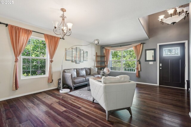 living room featuring baseboards, dark wood-style flooring, and a notable chandelier