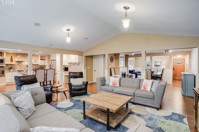 3664 W Chinook Ave, Cannon Beach, OR 97110 - living area featuring vaulted ceiling and light wood-style flooring