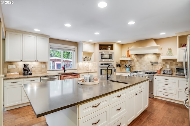 3664 W Chinook Ave, Cannon Beach, OR 97110 - kitchen with appliances with stainless steel finishes, custom exhaust hood, open shelves, backsplash, and recessed lighting