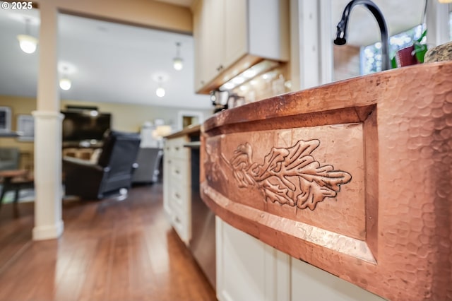 3664 W Chinook Ave, Cannon Beach, OR 97110 - detailed view of wood finished floors, decorative columns, and white cabinetry
