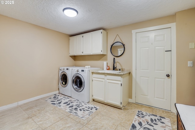3664 W Chinook Ave, Cannon Beach, OR 97110 - laundry area featuring cabinet space, independent washer and dryer, a textured ceiling, and light tile patterned flooring