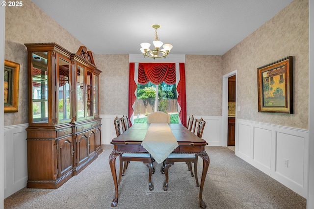 23836 SW Warbler Pl, Sherwood, OR 97140 - carpeted dining room featuring a chandelier, wainscoting, a decorative wall, wallpapered walls, and a textured ceiling