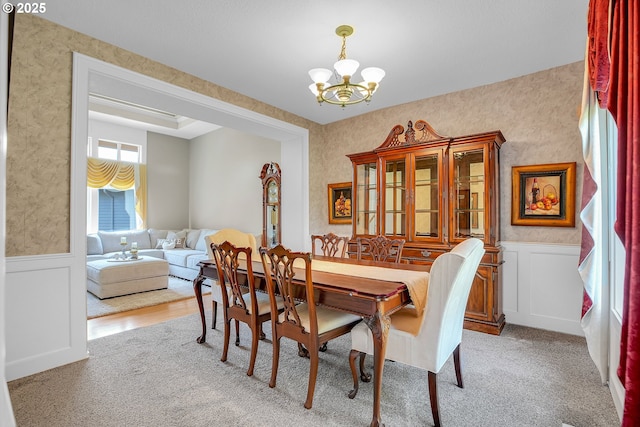 23836 SW Warbler Pl, Sherwood, OR 97140 - carpeted dining space with a chandelier, wainscoting, and a decorative wall