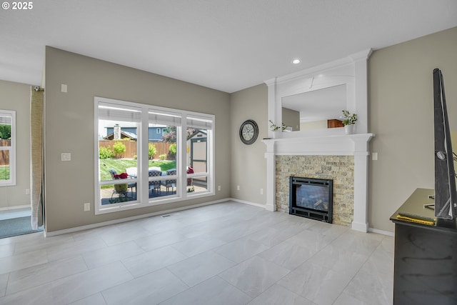 23836 SW Warbler Pl, Sherwood, OR 97140 - unfurnished living room with a stone fireplace, recessed lighting, and baseboards