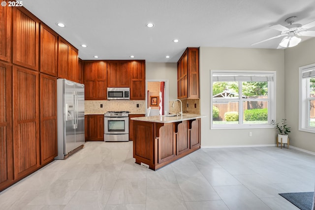 23836 SW Warbler Pl, Sherwood, OR 97140 - kitchen with appliances with stainless steel finishes, a peninsula, tasteful backsplash, recessed lighting, and a sink