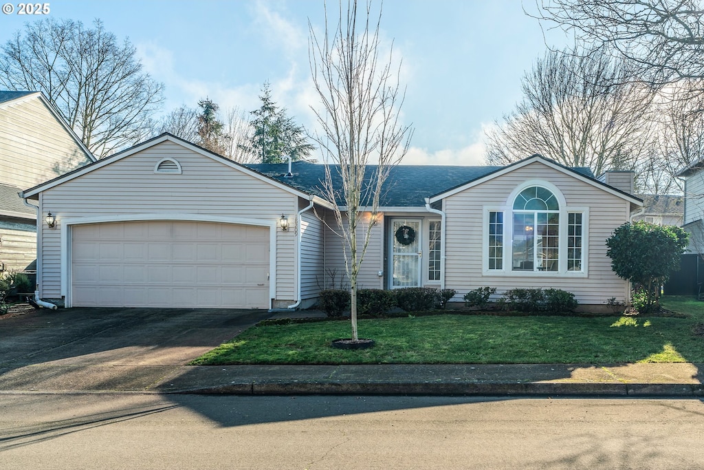 ranch-style house with a garage and a front yard