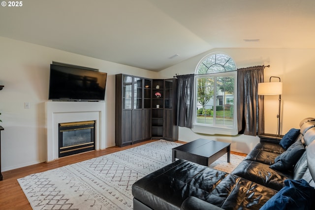 living room with wood-type flooring and lofted ceiling